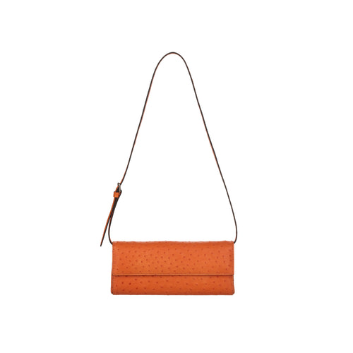 Orange clutch bag with a strap on a white background