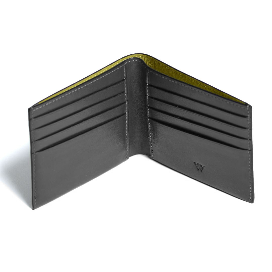 Open black leather wallet with green interior on a white background