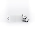 A white luxury leather purse with a geometric pattern, featuring a removable link strap and multiple compartments.