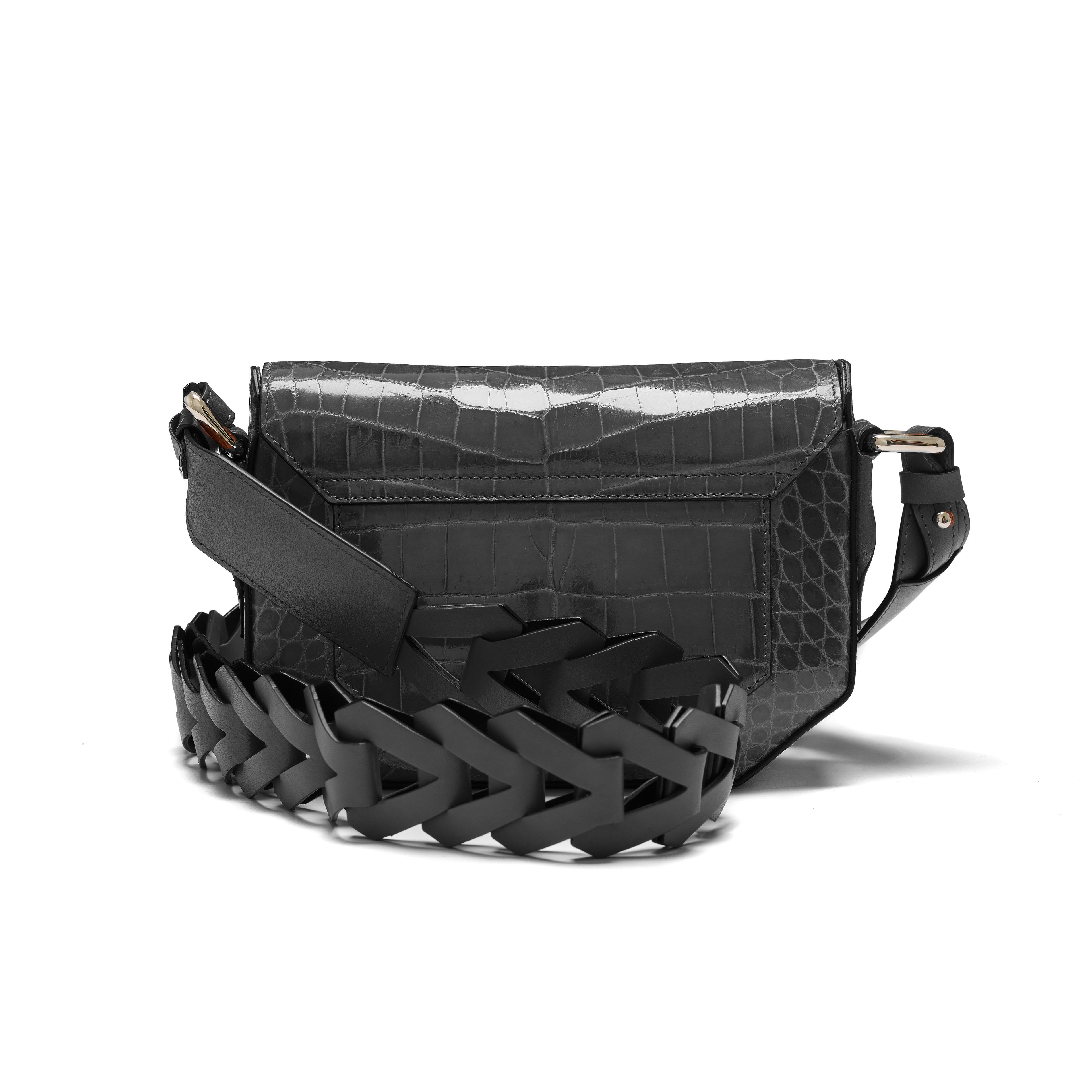 Black woven leather bag with crocodile texture on a white background