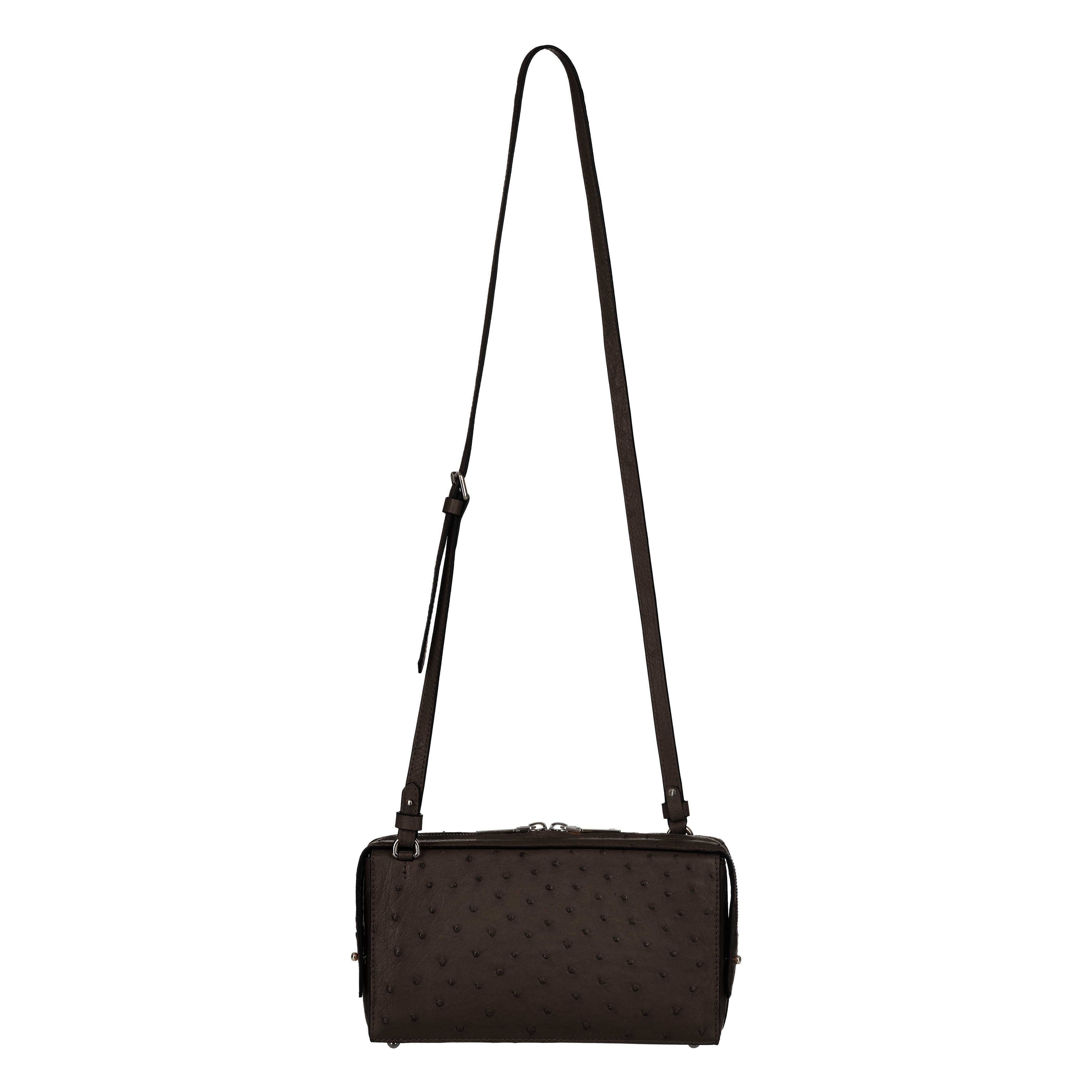 Black textured handbag with a strap on a white background