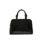 A black luxury handbag with a structured design, featuring two handles and a detachable strap.