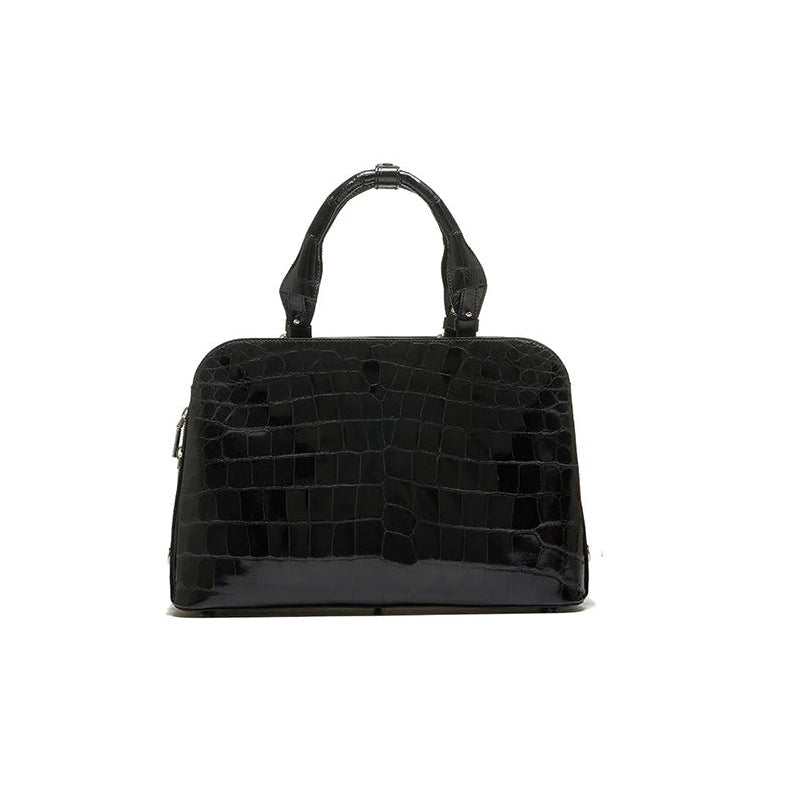 A black luxury handbag with a structured design, featuring two handles and a detachable strap.