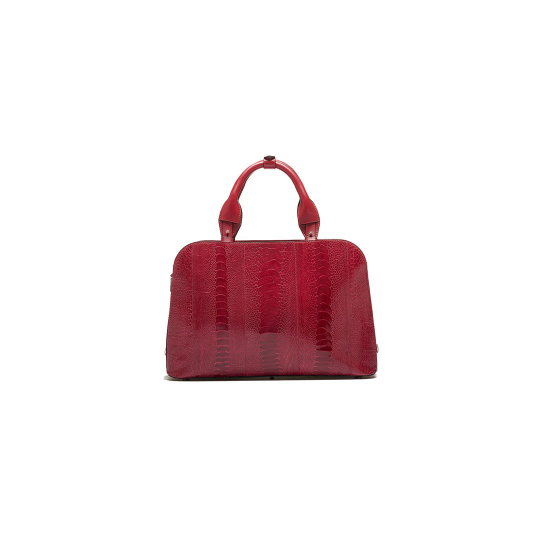A red, structured handbag with two handles and a long strap, made from a textured material resembling ostrich leg leather.