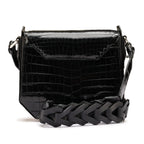 Black crocodile-patterned handbag with a braided handle on a white background