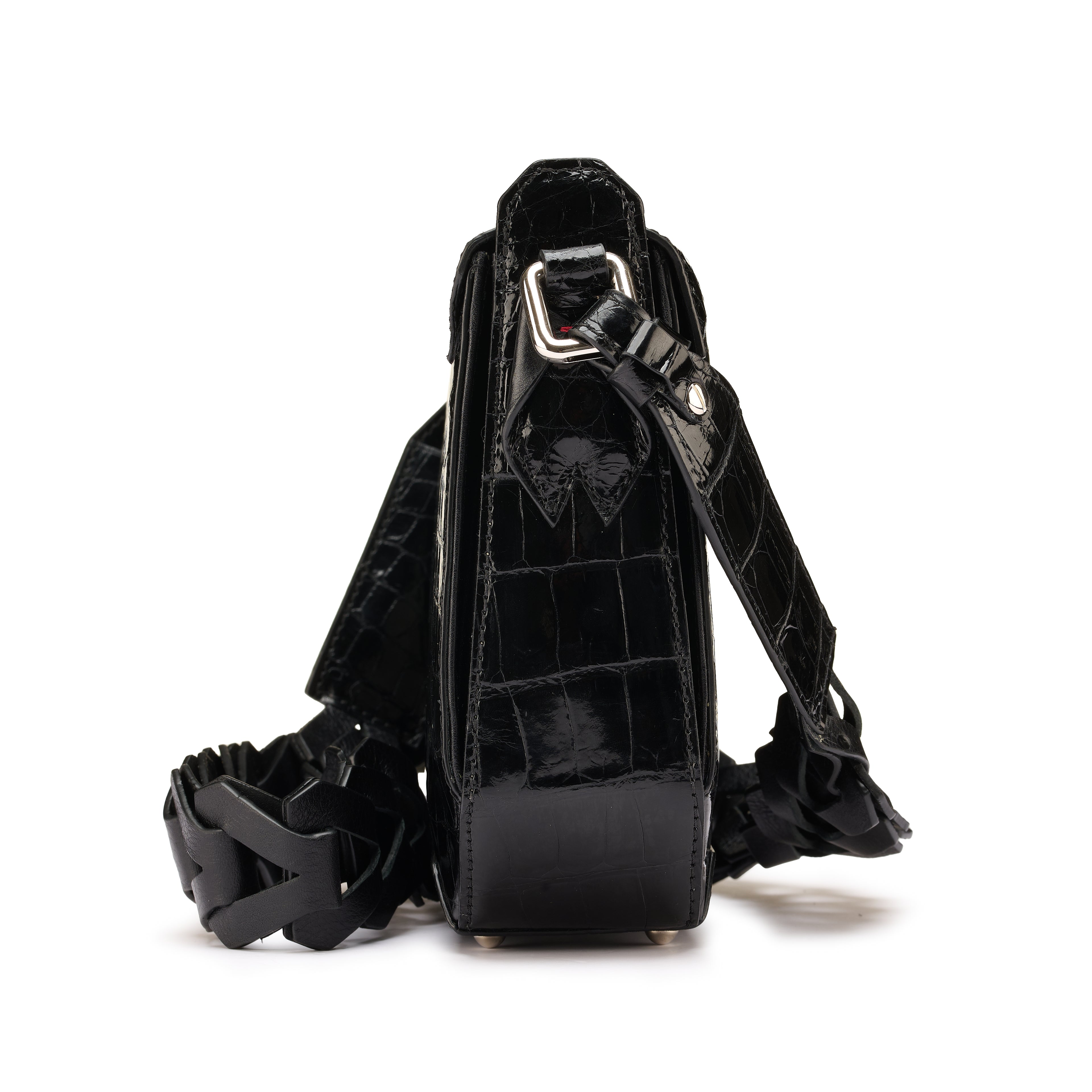 Black leather harness with intricate design on a white background