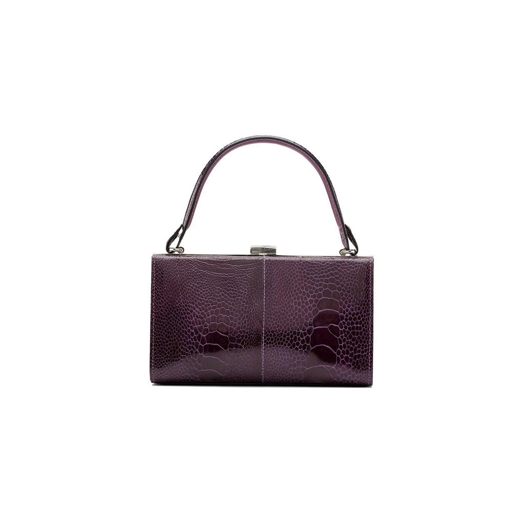 A purple leather purse with a solid pattern, featuring a hand carry and a link strap.