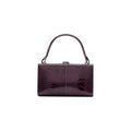 A purple leather purse with a solid pattern, featuring a hand carry and a link strap.