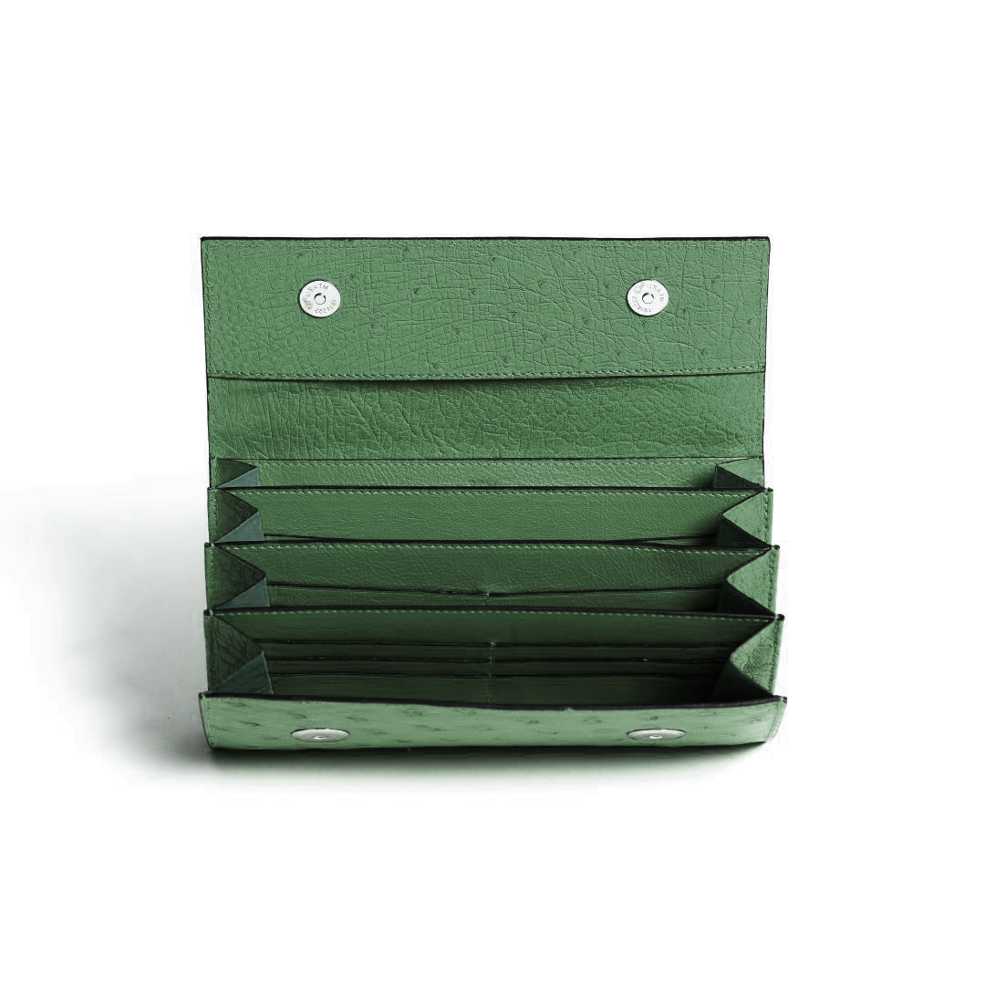 Green wallet with multiple card slots on a white background