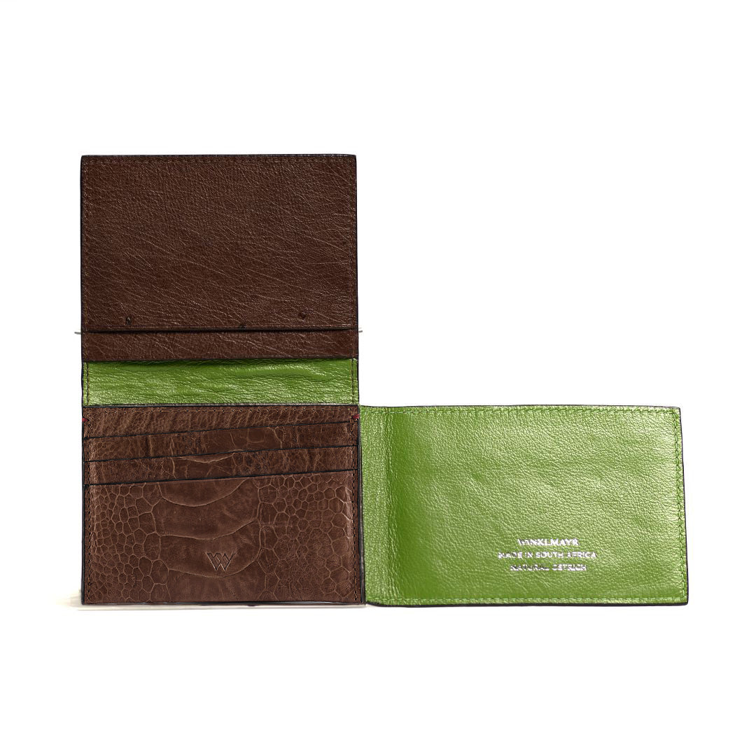 Brown and green leather wallets on a white background