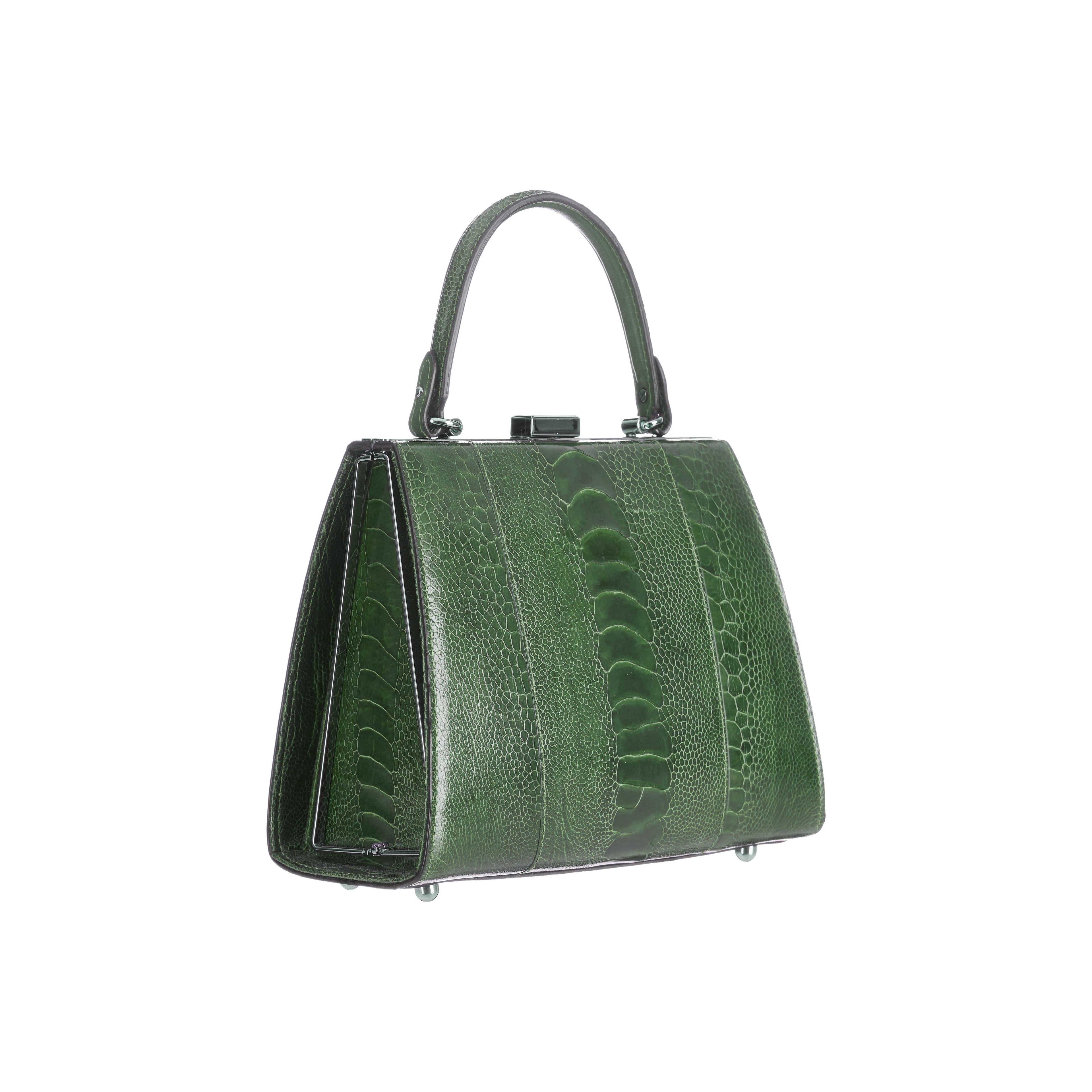 Green handbag with a textured pattern on a white background