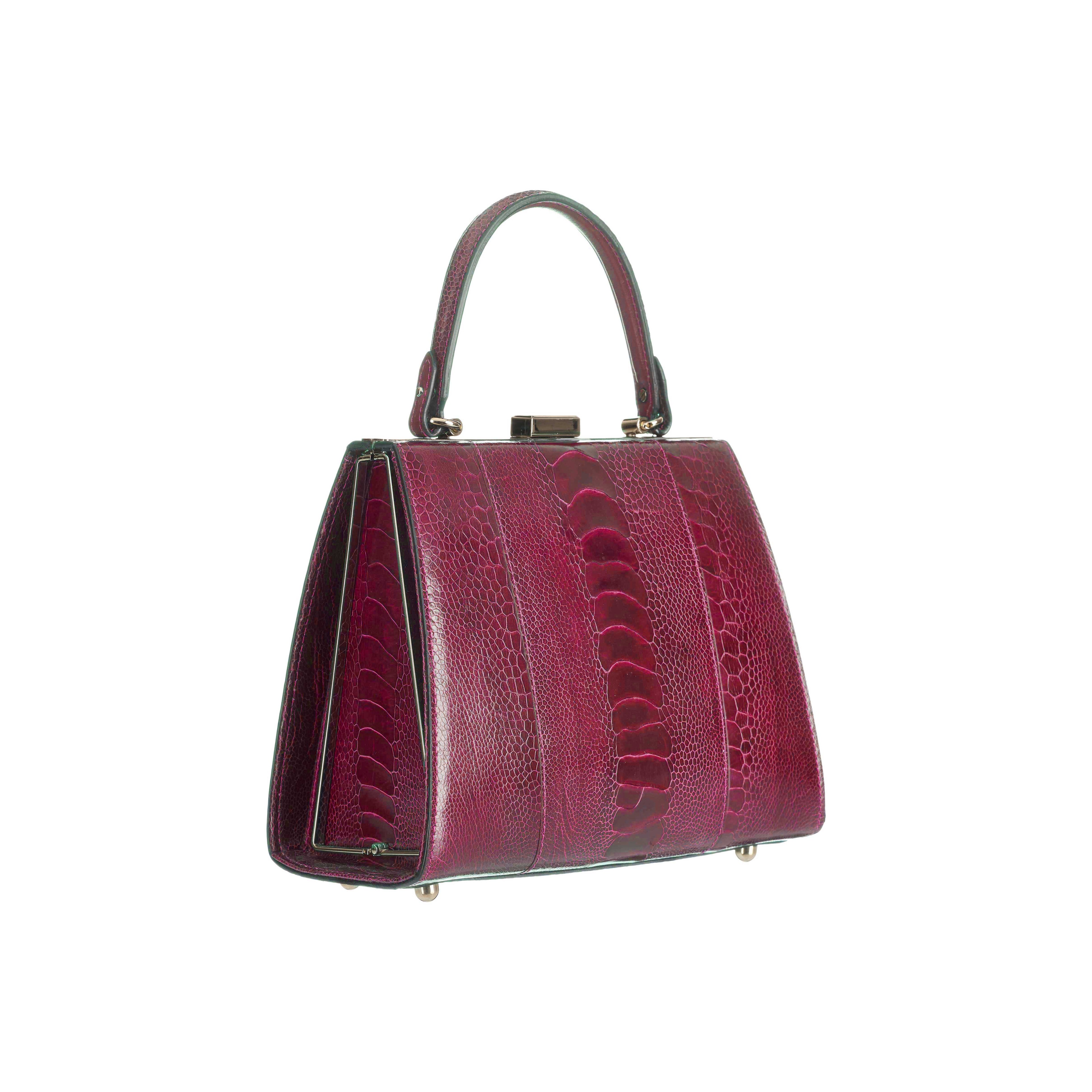 Red handbag with a textured pattern on a white background
