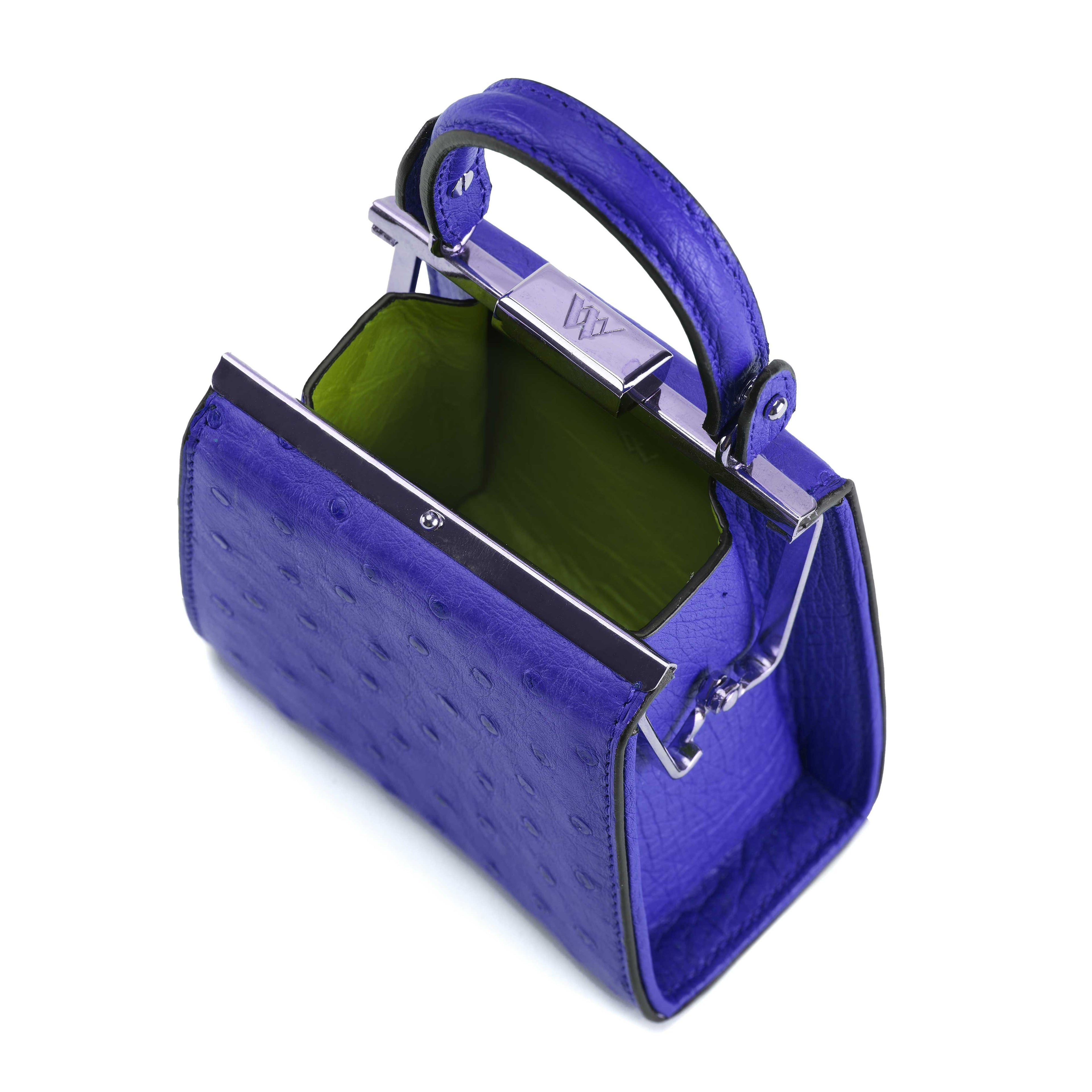 Blue handbag with a green interior on a white background