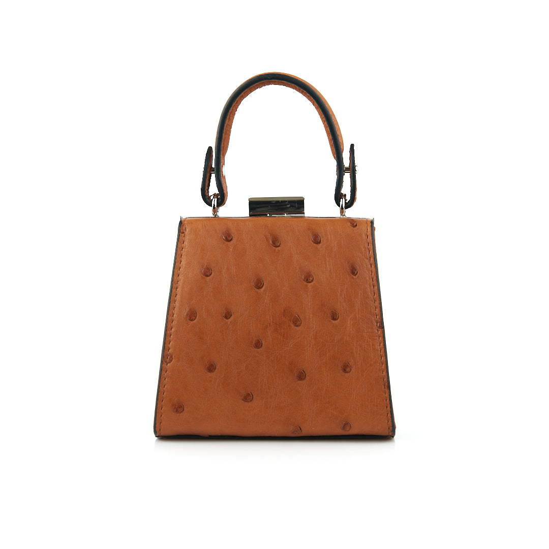 A cognac brown leather small clutch purse with a zipper top closure and a detachable handle.