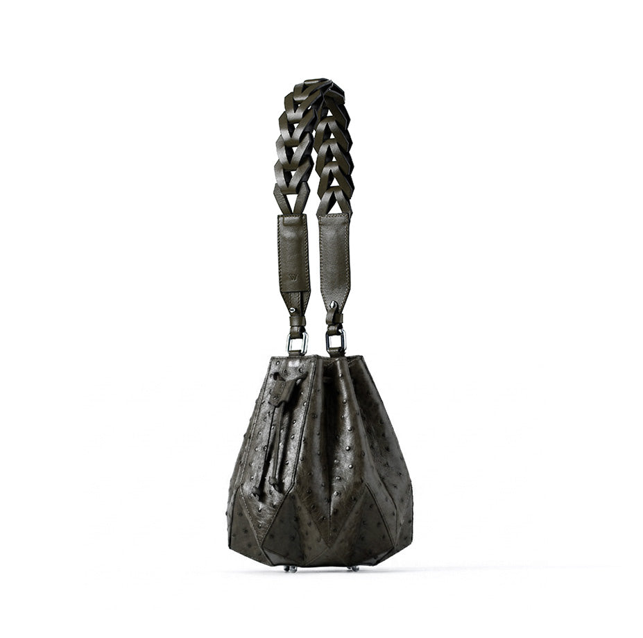 Black leather handbag with braided handle on a white background