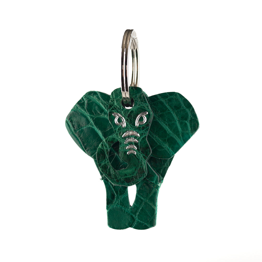 A green leather keyring in the shape of an elephant, with metal rings for keys.