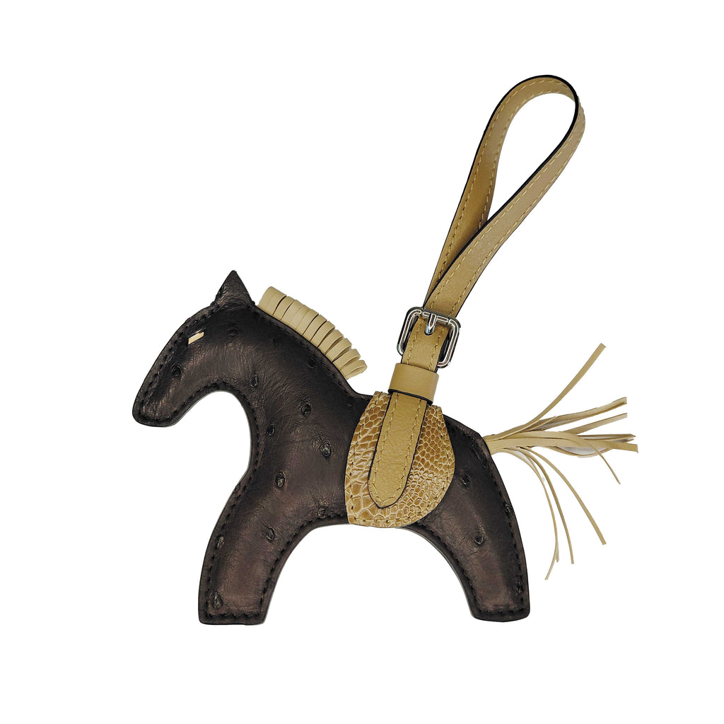Horse-shaped keychain with a strap on a white background