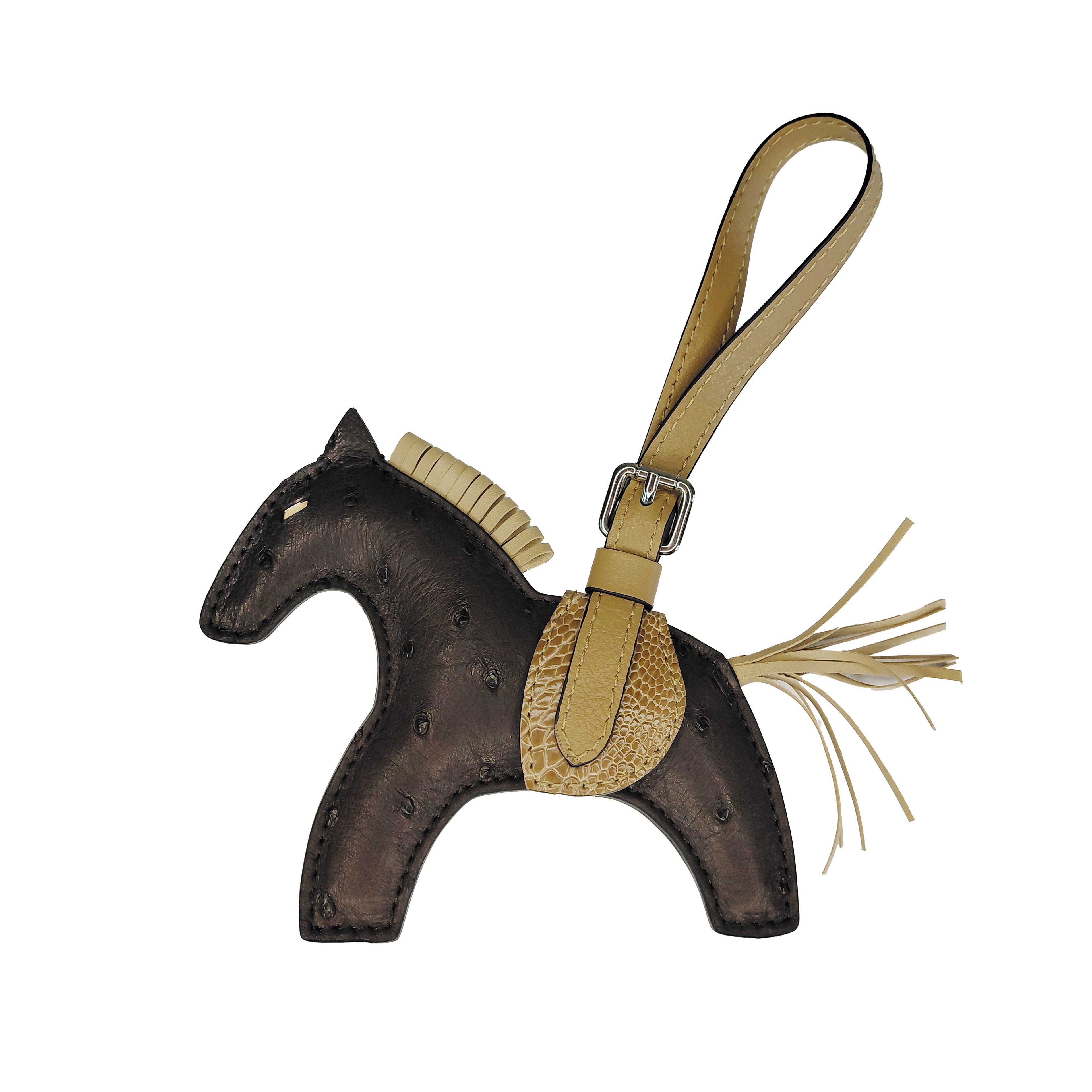 Horse-shaped keychain with a strap on a white background